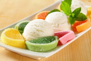 Scoops of white ice cream garnished with jelly candy