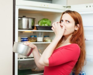 woman in red holding foul food